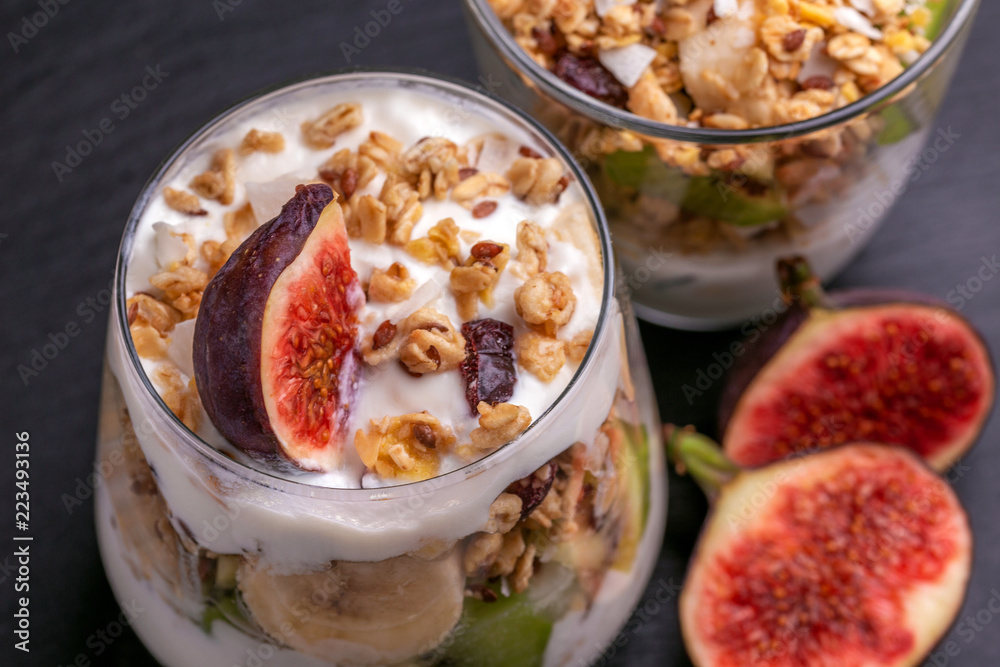 Granola with yogurt, bananas and figs. Copy space