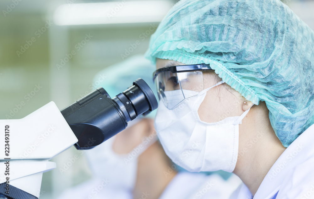 Scientist using a microscope in a laboratory, Concept science and Technology Scientist using a microscope in a laboratory, Concept science and Technology