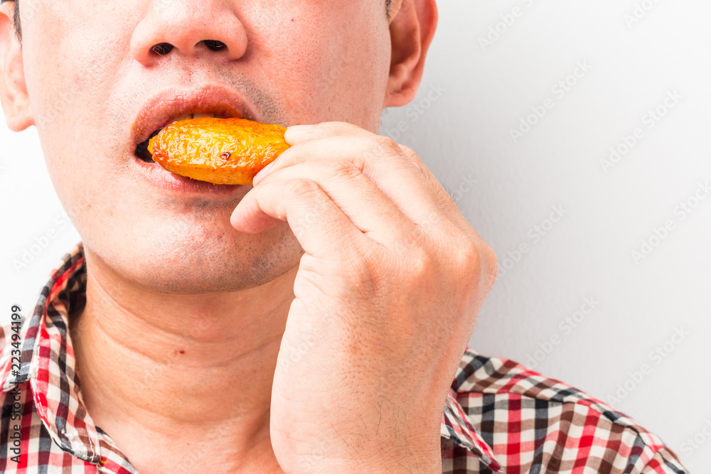 Young man eating fried chicken Young man eating fried chicken