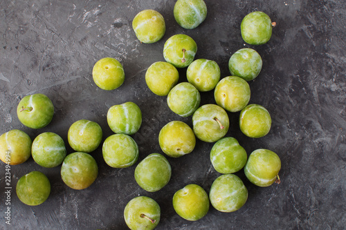 Delicious ripe green plums Greengages Black textured concrete background Autumn harvesting Flat lay Copy space photo
