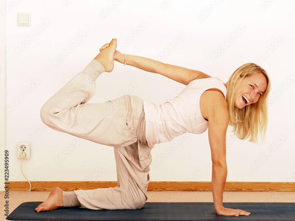 Young attractive woman practicing yoga, white background Young attractive woman practicing yoga, white background