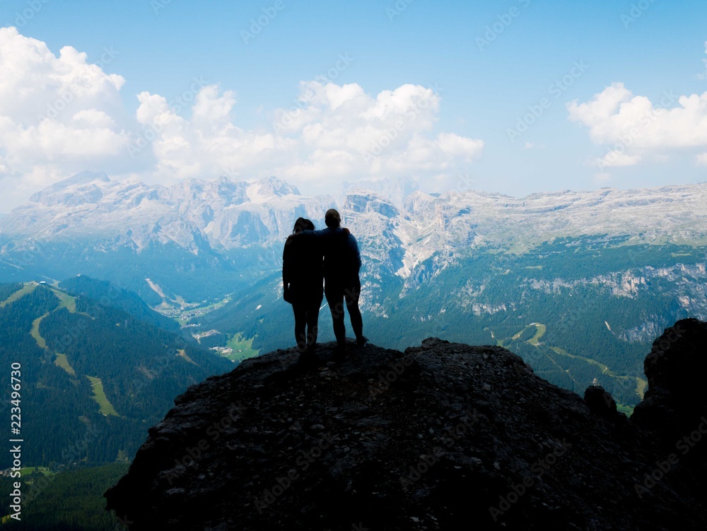 girls in silhouette look at the view from a mountain top, South Tyrol girls in silhouette look at the view from a mountain top, South Tyrol