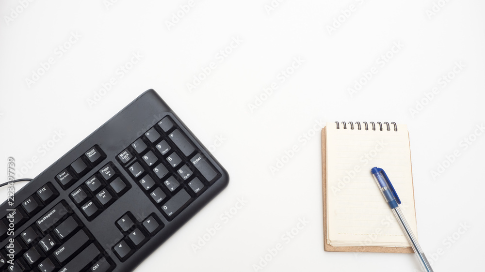 Office desk table with keyboard black and notebook Top view on white background Office desk table with keyboard black and notebook Top view on white background