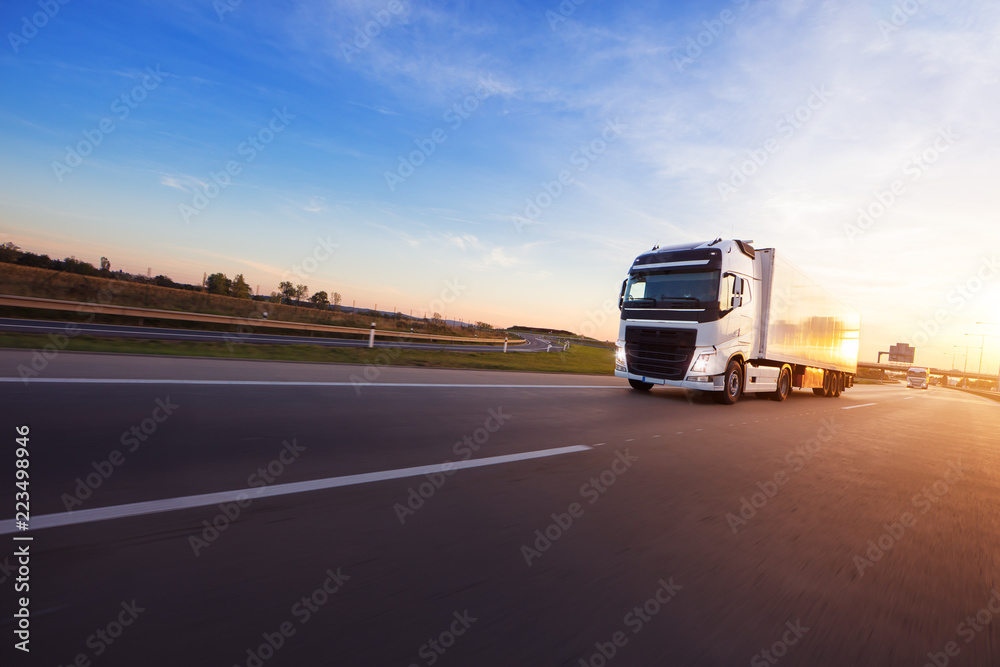 Loaded European truck on motorway in sunset