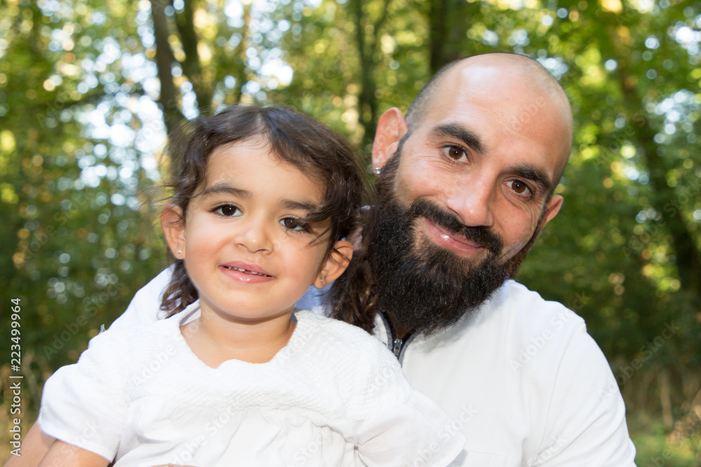 bald beard handsome man smile with girl daughter outdoor in summer day, happy family bald beard handsome man smile with girl daughter outdoor in summer day, happy family
