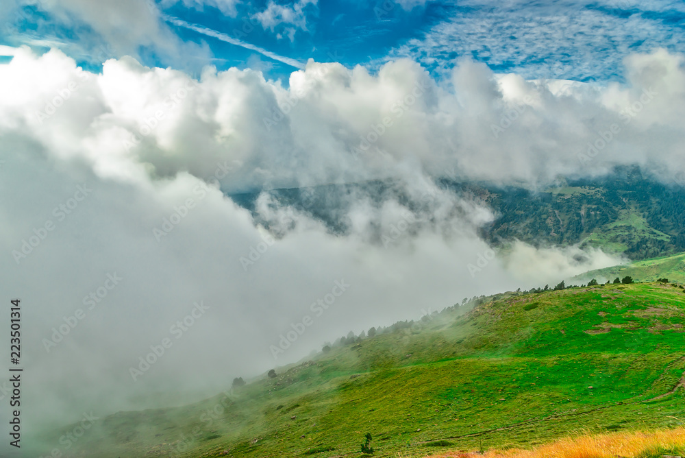 The fog advances over the meadows of the Pyrenees The fog advances over the meadows of the Pyrenees