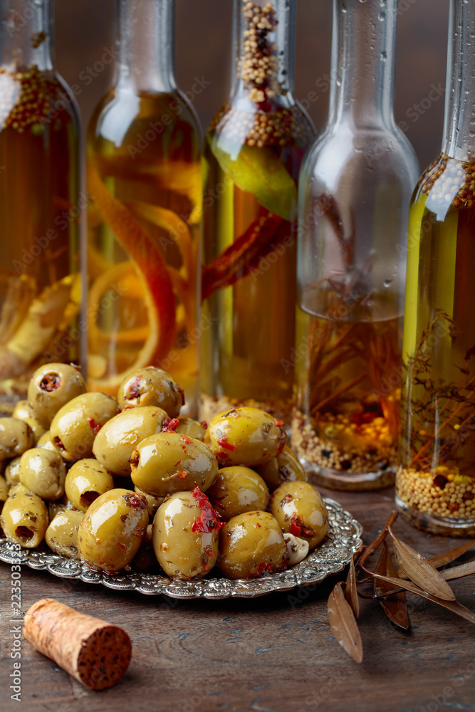 Spiced green olives and bottles with olive oil . Spiced green olives and bottles with olive oil .
