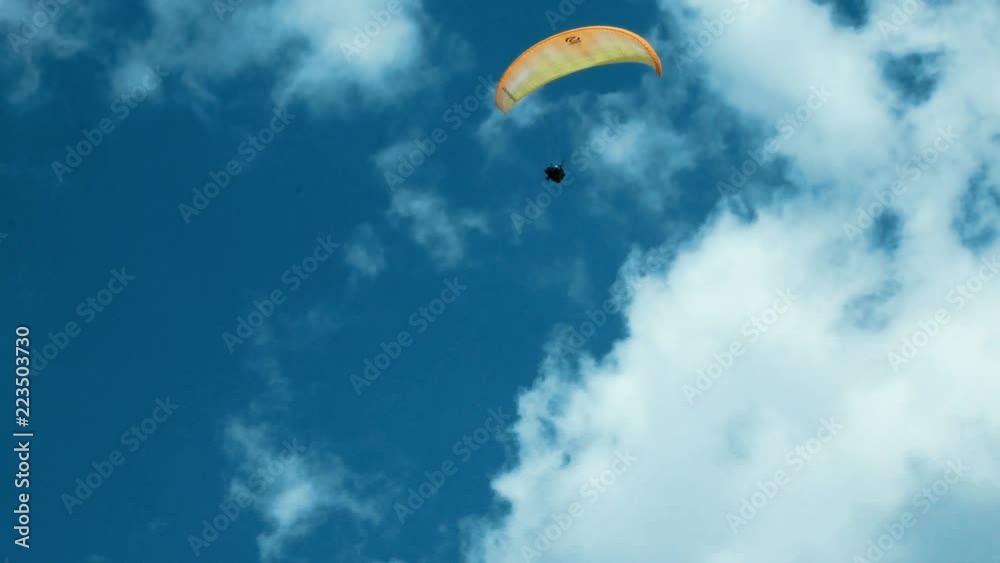 paraglider flies over a mountain top in South Tyrol paraglider flies over a mountain top in South Tyrol