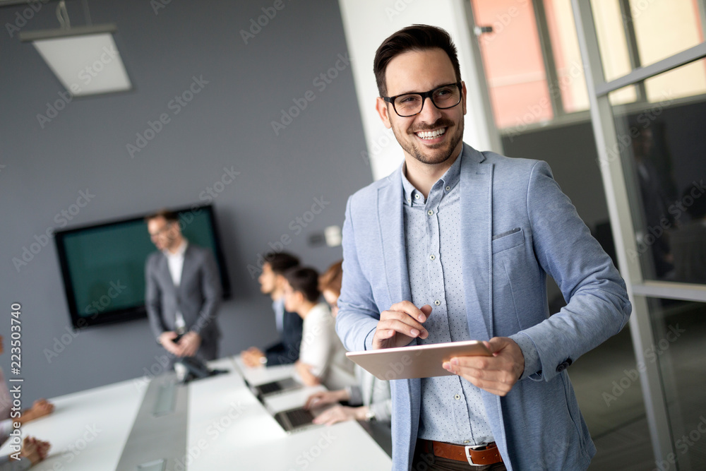 Group of business people collaborating in office Group of business people collaborating in office