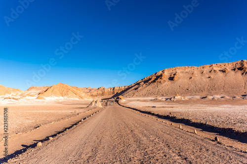 A emprty road in the middle of the Moon valley in the Atacama Desert  blue sky  Chile