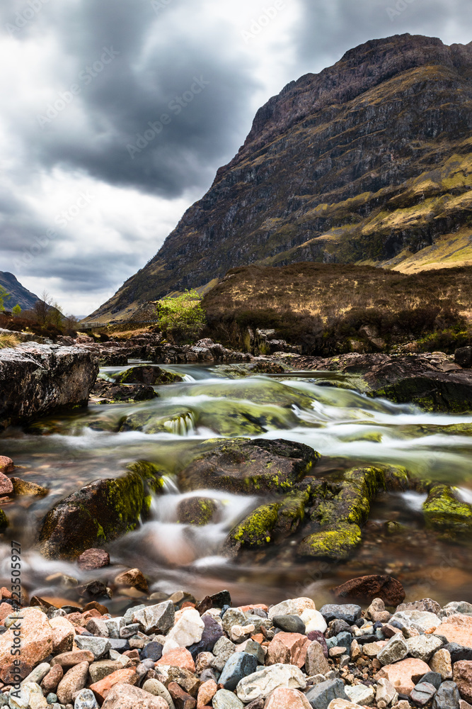 Glencoe river with smooth water flow and cloudy day. hill views at the back Glencoe river with smooth water flow and cloudy day. hill views at the back