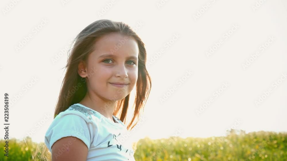 Portrait of attractive little girl with a big green eyes on nature background with developing hair Portrait of attractive little girl with a big green eyes on nature background with developing hair