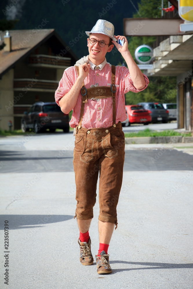 Handsome young man in traditional clothing with lederhosen and checkered  shirt in summer in Grimentz, Switzerland Stock Photo | Adobe Stock