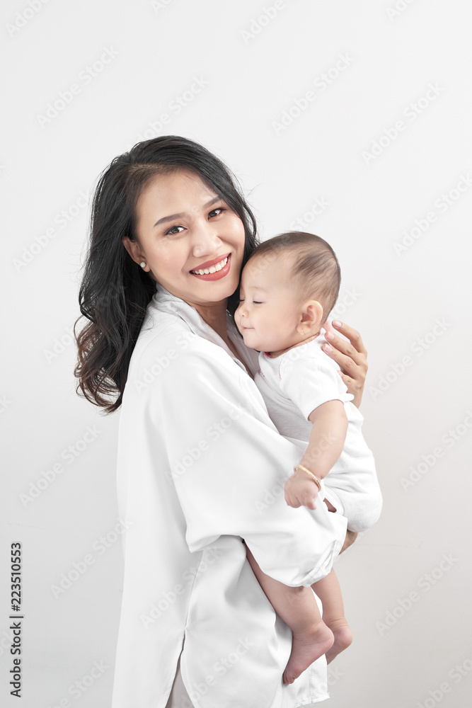 Motherhood and lifestyle concept. Smiling young mother with little baby at home Motherhood and lifestyle concept. Smiling young mother with little baby at home
