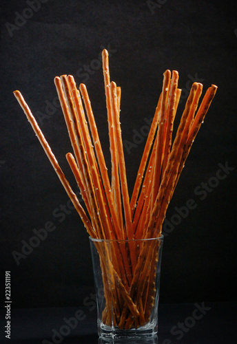 Pretzel sticks in small glass photo
