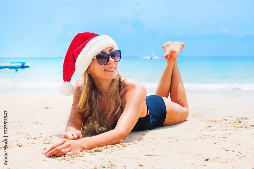 suntan woman relaxing beach christmas santa hat suntan woman relaxing beach christmas santa hat