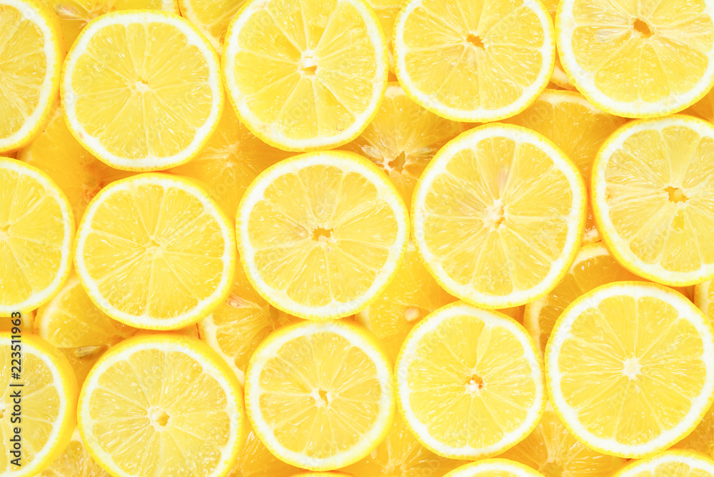 A slices of fresh juicy yellow lemons.  Texture background, pattern.