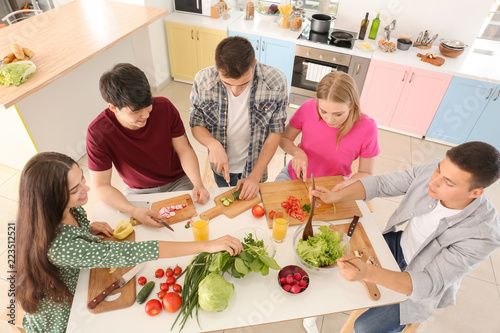 Friends cooking together in...
