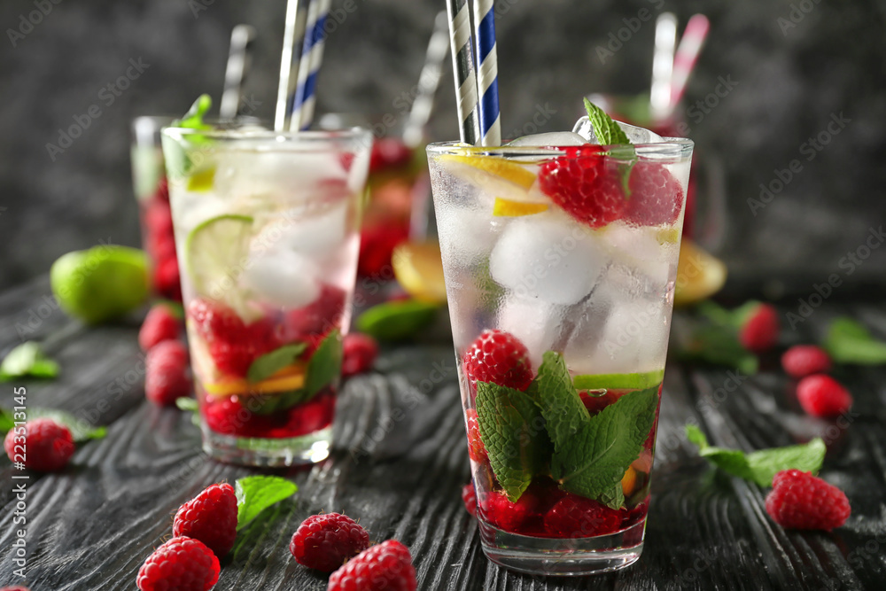 Glasses of fresh raspberry mojito on wooden table Glasses of fresh raspberry mojito on wooden table