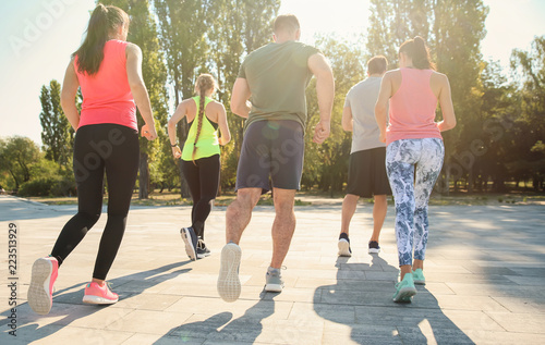 Group of sporty people runn...