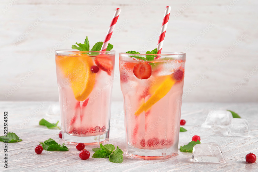 Fresh summer cocktail in glasses on light table Fresh summer cocktail in glasses on light table