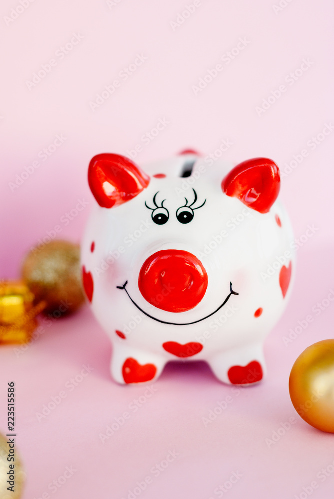Piggy bank over pink background with christmas decoration copy space. Year of pig 2019. Piggy bank over pink background with christmas decoration copy space. Year of pig 2019.