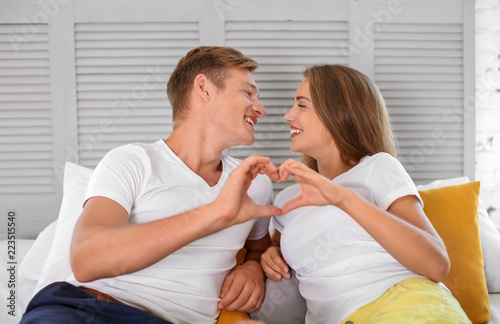 Young couple holding hands ...