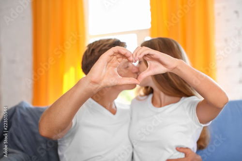 Young couple holding hands ...