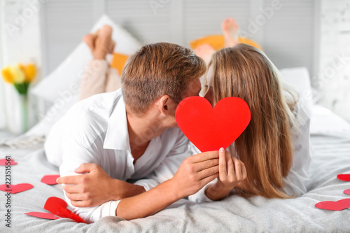 Happy young couple hiding f...