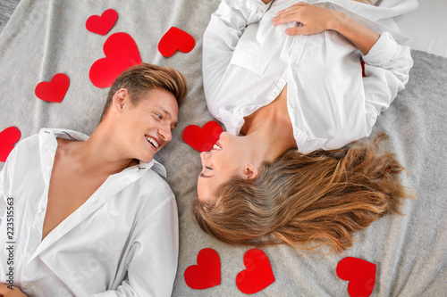 Happy young couple with red...
