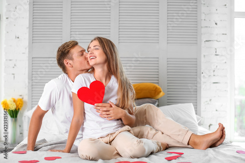 Happy young couple with red...