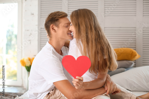 Happy young couple with red...
