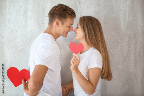 Happy young couple with red...