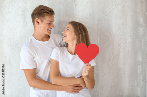 Happy young couple with red...