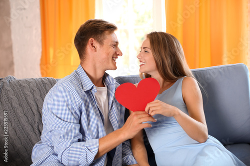 Happy young couple with red...