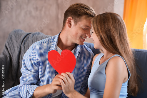 Happy young couple with red...