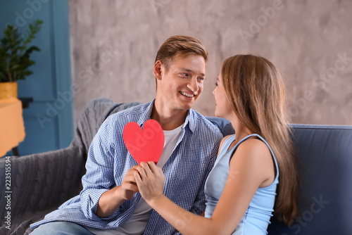 Happy young couple with red...