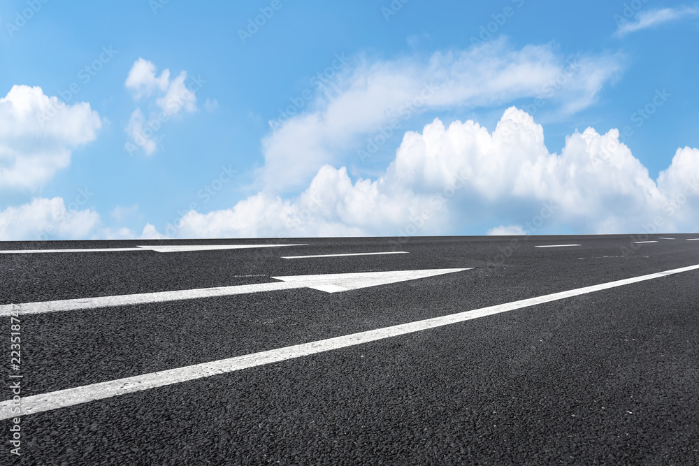 Road pavement under blue sky and white clouds