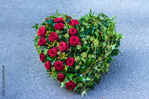 Funeral wreath - ikebana in a shape of the heart isolated on a white background