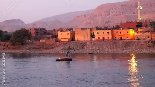  View of Beautiful Egiptian village from a Nile river cruise at sunset photo