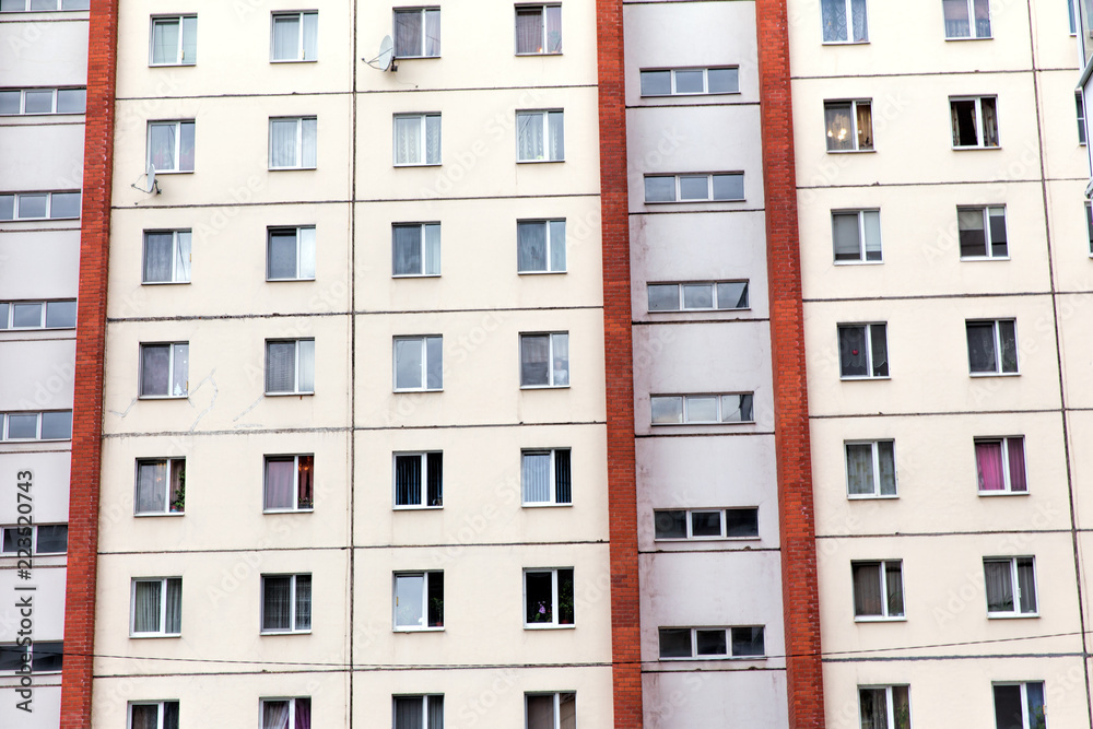 Naklejka premium Multi-storey residential building. Facade with windows