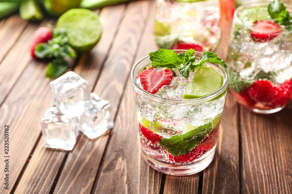 Glass of fresh strawberry mojito on wooden table Glass of fresh strawberry mojito on wooden table