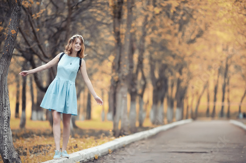 Young girl on a walk in the autumn 