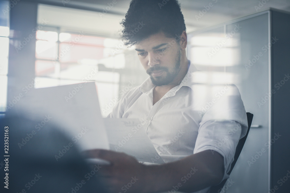 African business man reading document. African business man reading document.