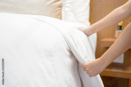 Hands Making Bed from Hotel Room Service © papzi