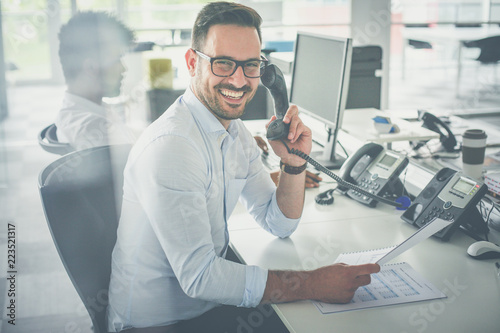 Photos Caucasian business man having conversation on Landline phone.