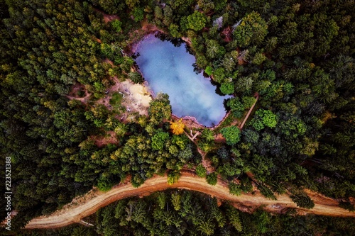 A beautiful view from the drone on a blue lake and forest located in the Rudawy Janowickie mountains, Poland