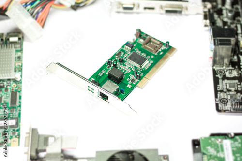 Ethernet card with computer parts on white background. Selective focus