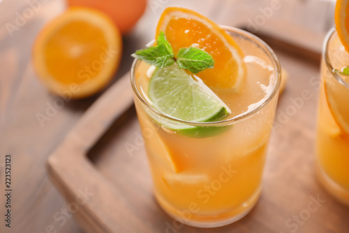 Fresh summer cocktail in glass on wooden board, closeup