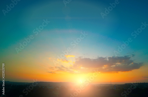 Beautiful sunset sky above clouds with dramatic light.